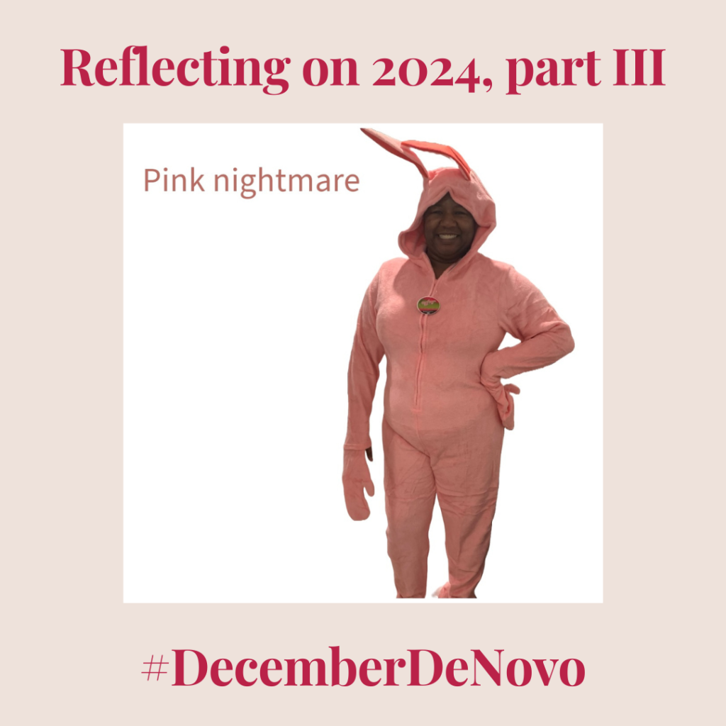 black woman in a pink bunny suit on a white background with text "pink nightmare" in the left corner