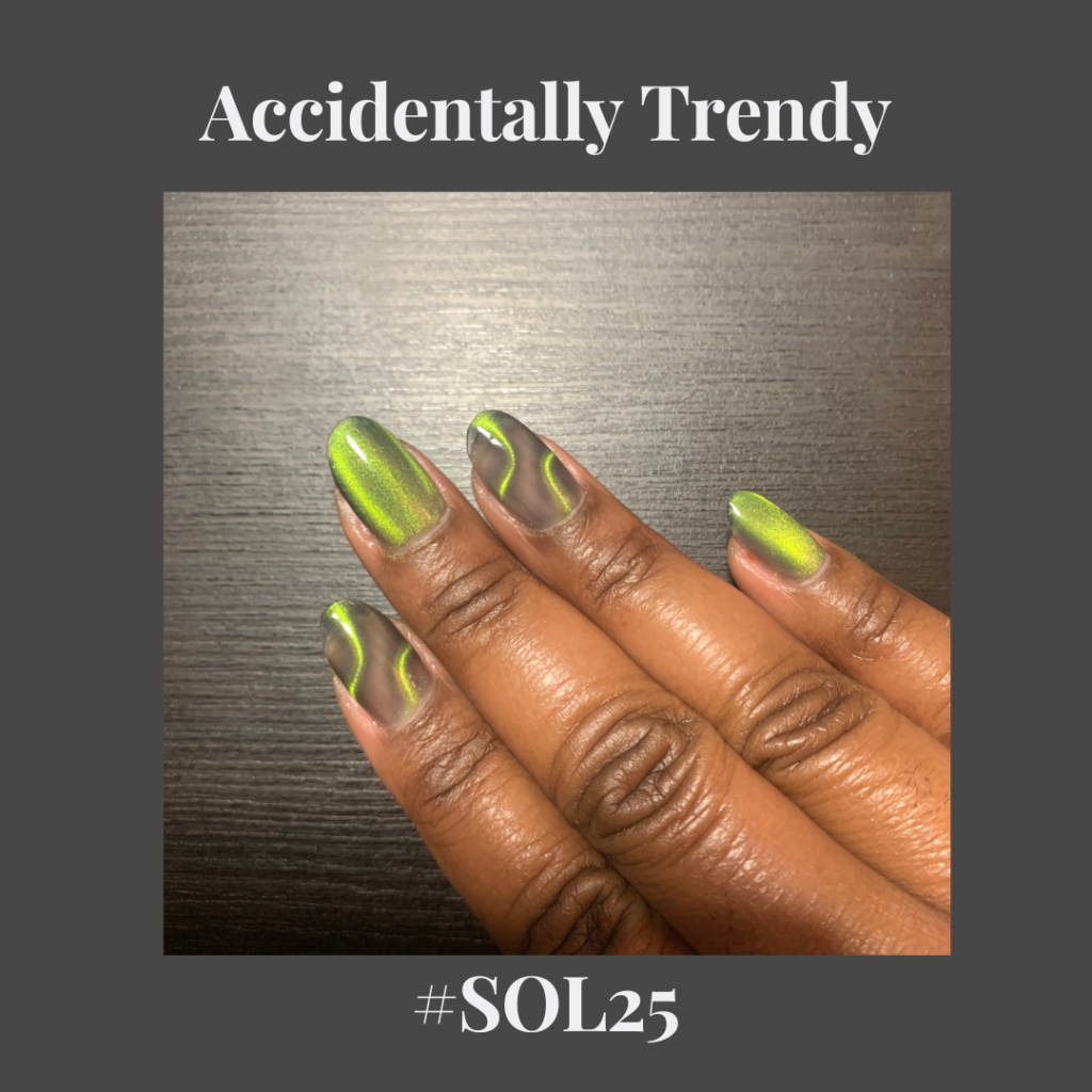 brown hand with green cat eye nail polish